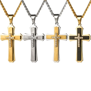 Detailed view of layered stainless steel cross pendants with zircon accents in four colors