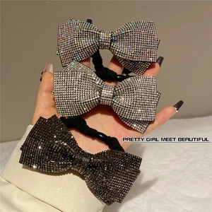 Handmade rhinestone bow hair ties in silver, iridescent, and black with elastic bands