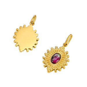 Detail of a vintage gold oval pendant with turquoise inlay and sunburst edge design