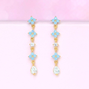 Detail of 18K gold flower drop earrings with blue zircon and teardrop crystal stones
