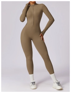 Close-up of brown long sleeve yoga jumpsuit featuring a half-zip neckline and ribbed texture