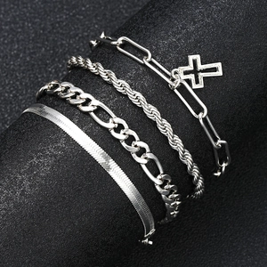 Detail of layered silver cross pendant, Cuban link, and snake chain bracelets on a black display