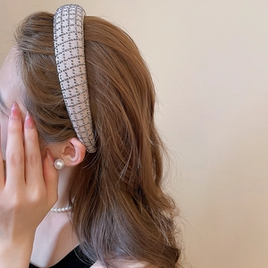Detail of rhinestone mesh headband with apricot silk base and thick padded design