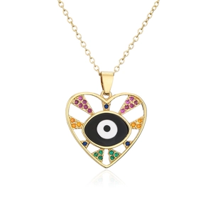 Macro detail of gold evil eye heart pendant with colorful zircon stones on white background