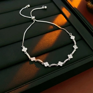 Close-up of silver four-leaf clover bracelet with white zircons and adjustable clasp