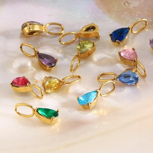 Macro shot of colorful teardrop zircon pendants with 18K gold-plated stainless steel edges