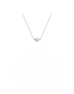 Detail view of a white Swarovski pearl pendant on a delicate silver chain necklace