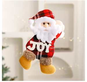 Detail of Santa plush ornament with red plaid fabric and white JOY lettering on its belly