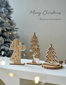 Detail of wooden Christmas tree and angel table ornaments with rustic wood grain finish