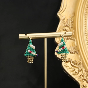 Handmade Christmas tree earrings with colorful beads and natural pearls on a gold stand