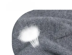 Detail of breathable dark gray knit wool fabric showing fine texture and softness