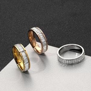 Macro detail of three-tone eternity rings with baguette-cut zircon in channel setting