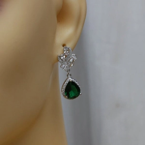 Elegant silver pear-shaped emerald green zircon drop earrings for women on ear