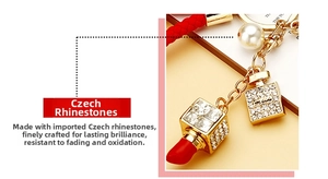 Detailed view of lipstick keychain featuring sparkling Czech rhinestones and red woven rope