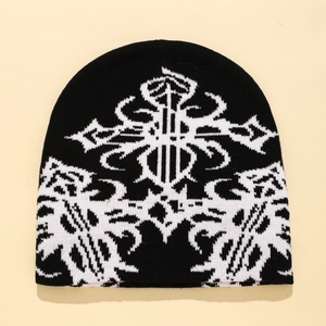 Black and white knitted beanie with abstract cross patterns and geometric jacquard design
