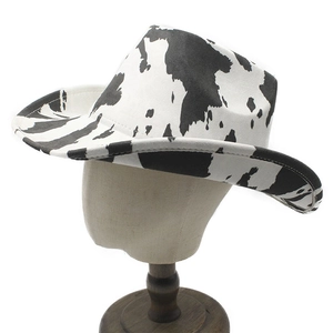 Detail of western cow print cowboy hat showing soft suede texture and curved brim
