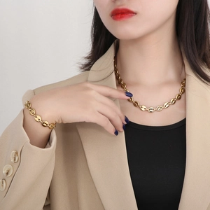 Polished gold pig nose link necklace and bracelet set shown on a model neck