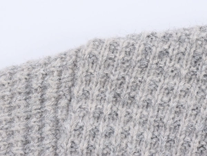 Detail of grey chunky knit fabric with subtle metallic silver sparkles for a cozy texture