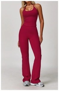 Detail of burgundy halter neck top and high-waisted flared yoga pants set with stretch fabric