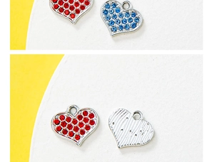 Detail of heart-shaped charms with red and blue rhinestones and silver stripes