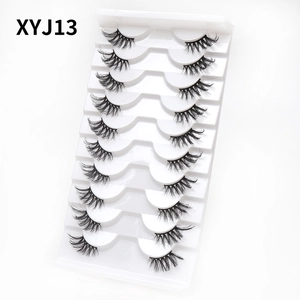 Detail of 10 pairs cat eye false eyelashes in white tray showing natural volume and curl
