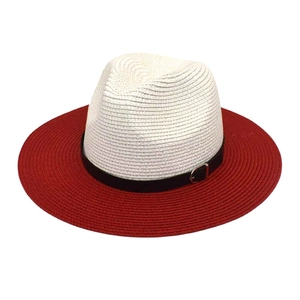 Détail d'un chapeau de paille pliable avec calotte crème et bord rouge avec une boucle