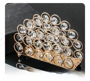 Close-up of golden crystal napkin holder with detailed metal rings and faceted gems