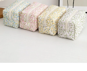 Detailed set of four quilted floral toiletry bags in blue, pink, yellow and purple hues