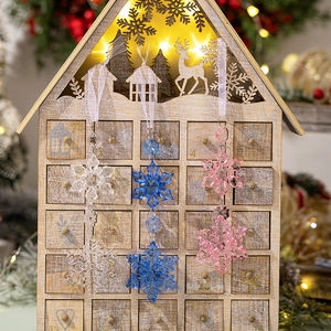 Macro shot of colorful hexagonal snowflake ornaments hanging against a festive background