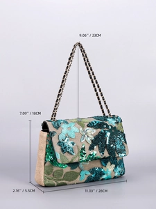 Detail of embroidered floral sequins on a beige woven shoulder bag with chain strap