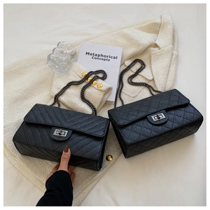 Detail of black chevron and quilted shoulder bags with vintage metal chain straps