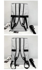 Detail of gray oxford backpack featuring padded straps and detachable shoulder strap