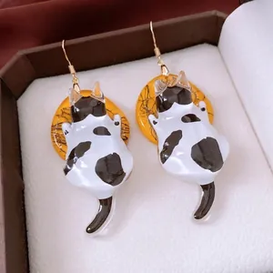 Creative resin cat earrings with black and white kitten pendants and gold hooks