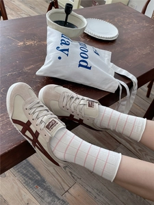 Detail of soft beige striped crew socks paired with casual shoes in a lifestyle setting
