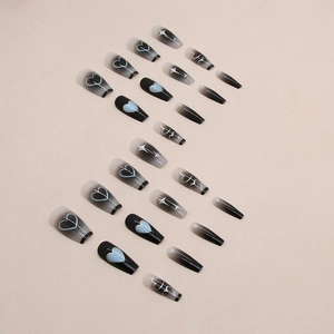 Long coffin fake nails with black gradient blush, blue hearts, and silver star patterns