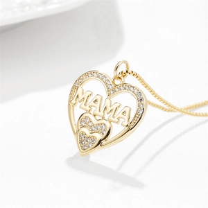 Close-up of golden heart pendant with MAMA lettering and sparkling zircon stones