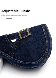 Detail of adjustable metal buckle and contrast stitching on blue denim newsboy cap