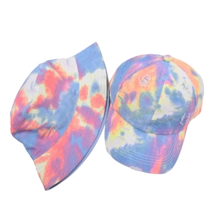 Detailed set showing tie-dye cotton bucket hat and baseball cap with frayed edges