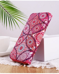 Pink bohemian mandala wallet with zip closure displayed on a white block in a cozy scene