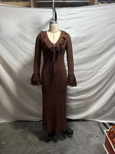 Detail of V-neckline with ruffle trim and tiered bell sleeves on a knit maxi dress