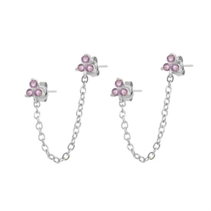 Macro view of silver ear cuff chain featuring sparkling pink zirconia flower studs