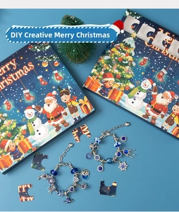 Detailed view of DIY Christmas advent calendar box with blue charm bracelets and snowflake charms
