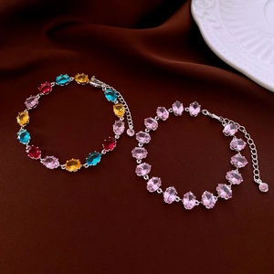Detailed macro view of oval-cut zircon bracelets with secure four-prong setting and lobster clasp