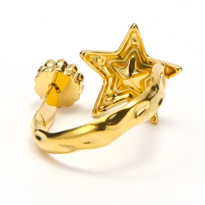 Detail of gold-plated star ring with hammered texture and adjustable open band