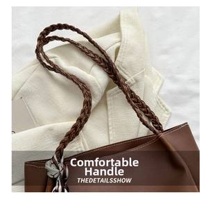 Close-up of brown leather tote bag with woven handles and decorative printed silk scarf