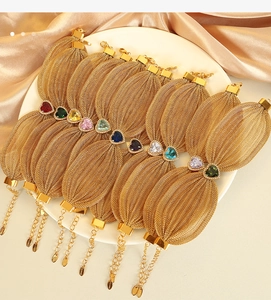 Detailed close-up of heart-shaped crystal mesh bracelets in various colors on white plate