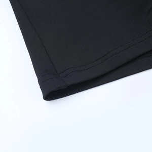 Close-up of double-needle stitching on the hem of a black long-sleeve knit two-piece set