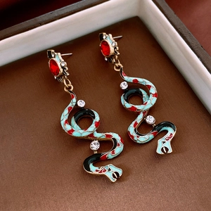 Detailed view of snake earrings with colorful enamel oil drops and sparkling rhinestones
