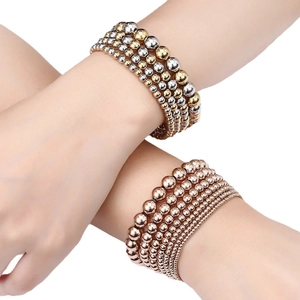 Minimalist multi-layer beaded bracelet set in gold silver and rose gold metallic tones