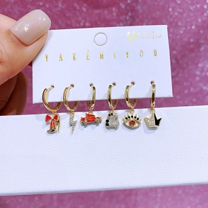Detailed macro view of 6-piece colorful enamel and zircon earring set on display card